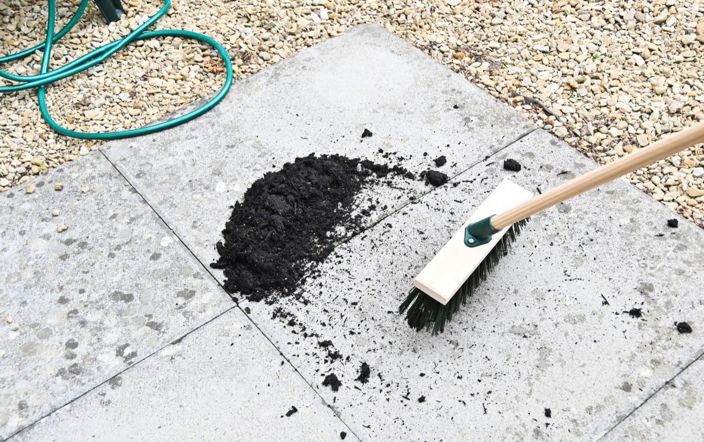A stone patio being swept clean